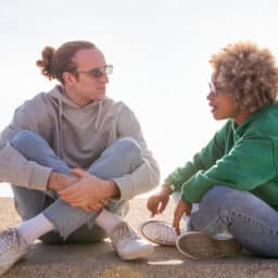 Couple sitting on the beach talking