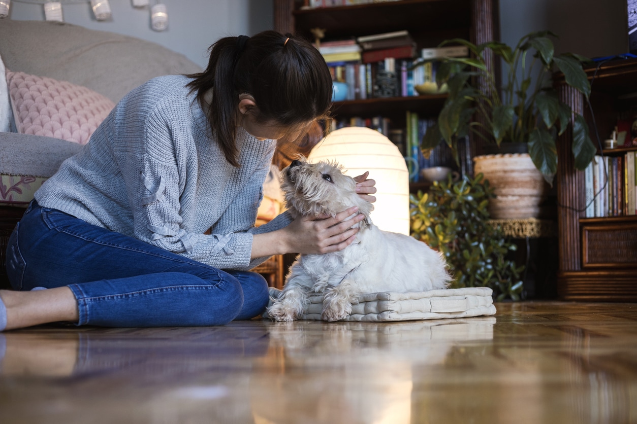 Woman with hearing aids pets her dog