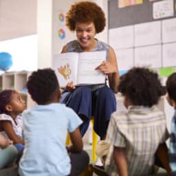 Teacher reading to a group of school children