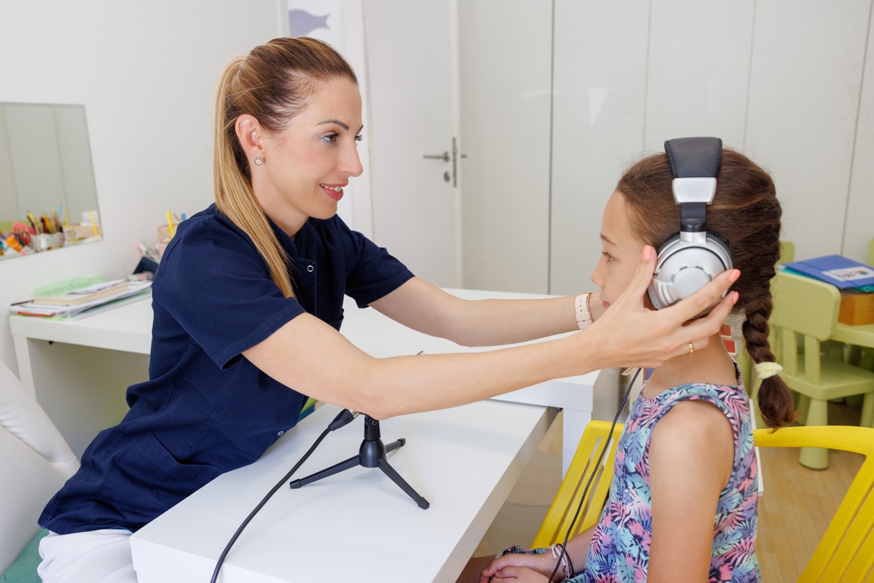 Young girl in a school ear exam.