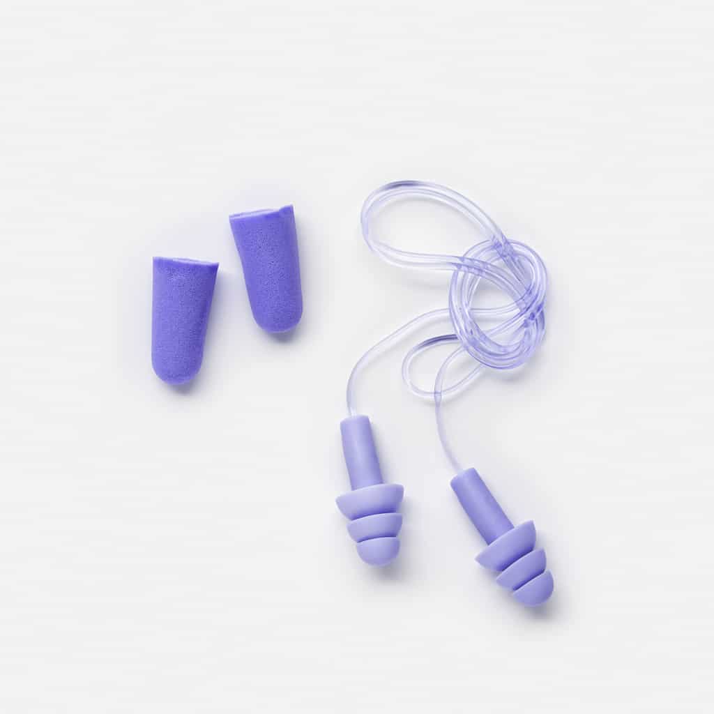 Different earplugs on white background, comfort silicone and rubber ear plug on string protection against noise.